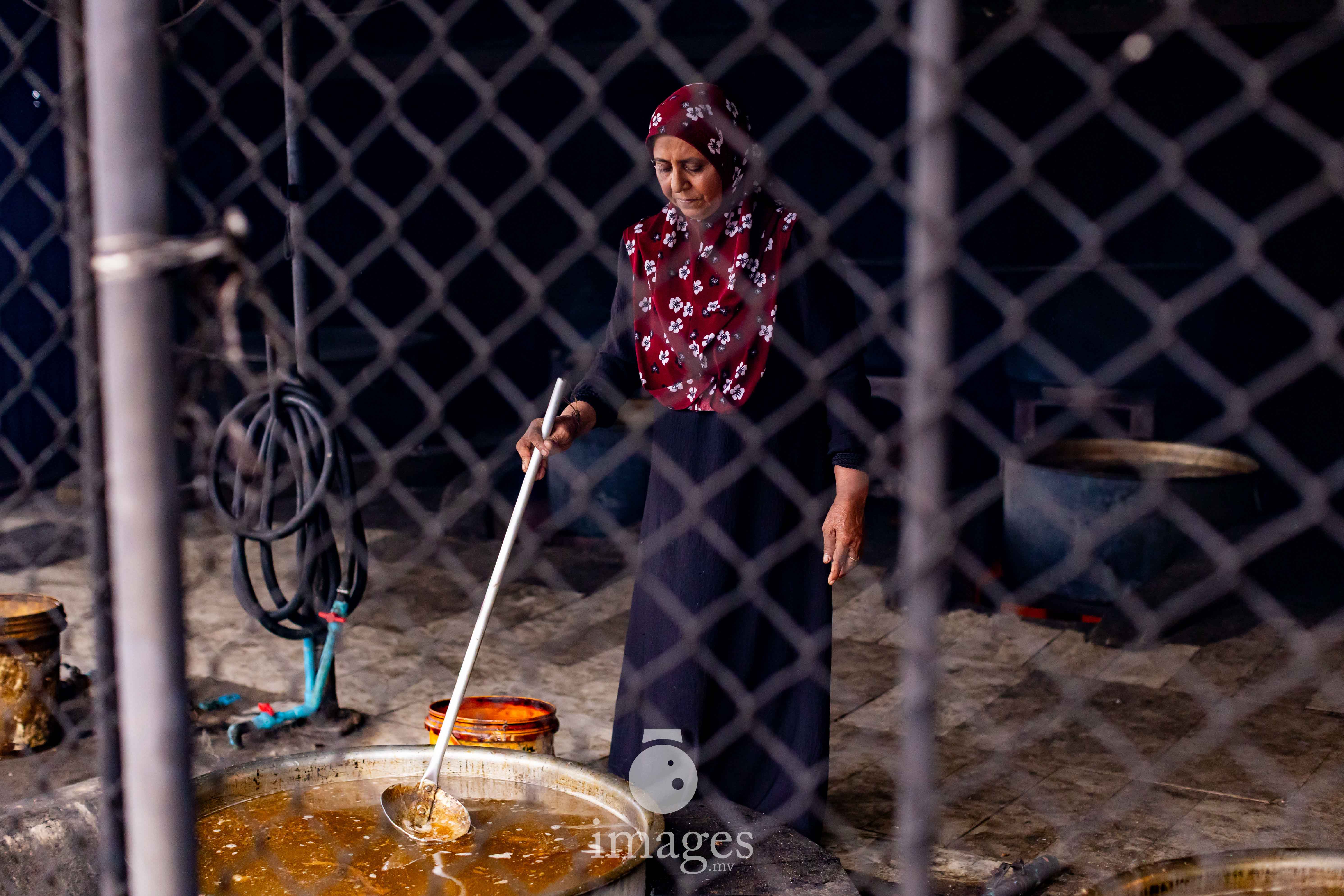 With a steady hand and decades of experience, a woman stirs the boiling stock — guiding heat, movement, and time into the transformation of ocean into heritage.
