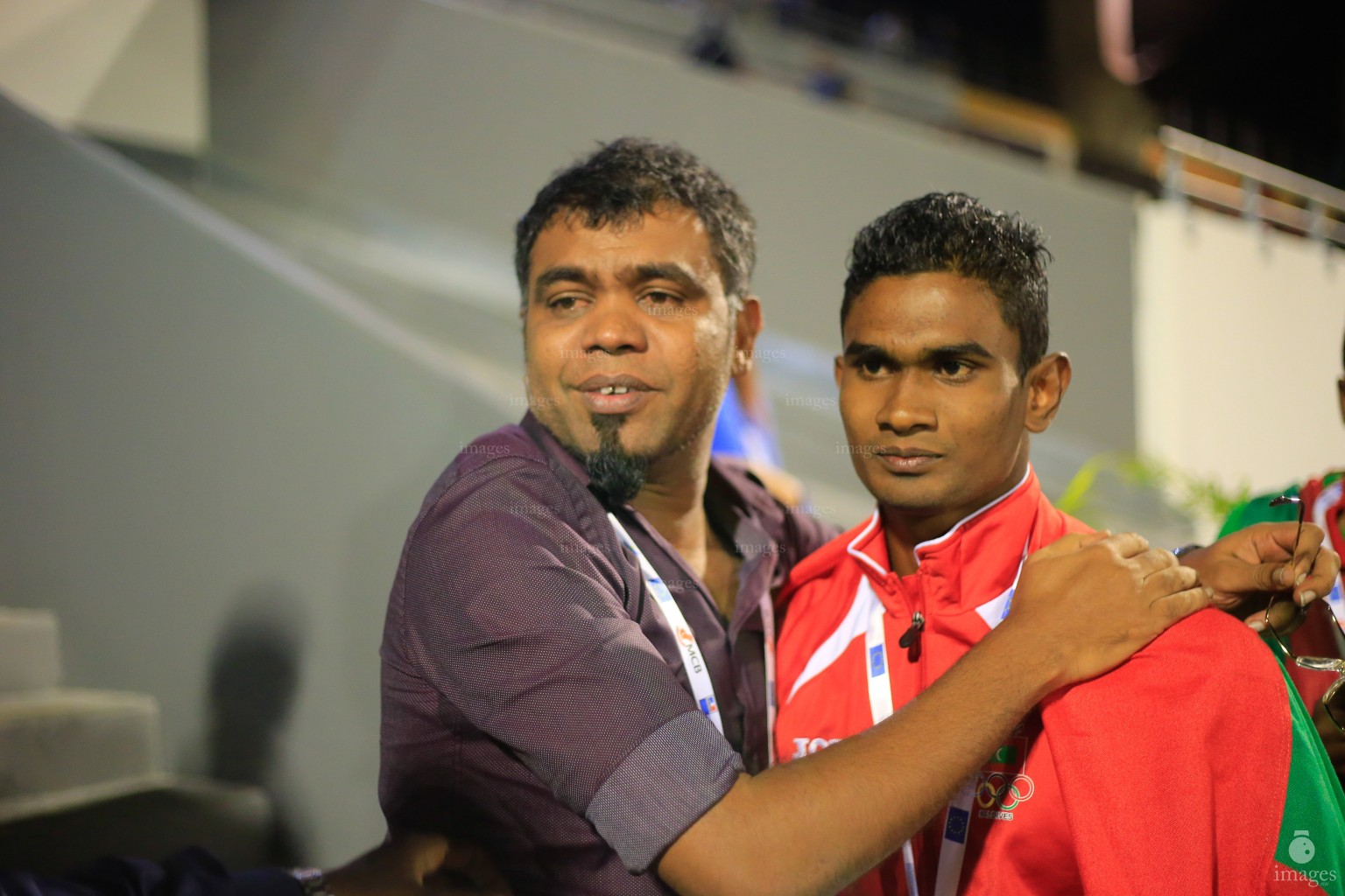 Hassan Said celebrates with Maldives Olympic Committee general secretary after finishing first in the 100m finals in Indian Ocean Island Games, La Reunion, Sunday, August. 2, 2015.  (Images.mv Photo/ Hussain Sinan).