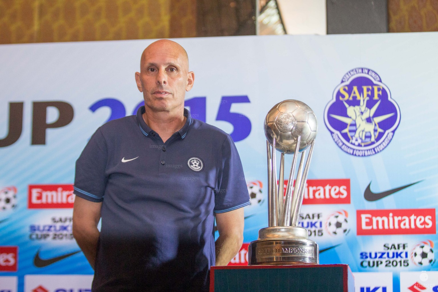 Indian coach poses with the SAFF Suzuki Cup trophy ahead of the  finals in Thiruvananthapuram, India, Thursday, January. 2, 2015.(Images.mv Photo/ Hussain Sinan).